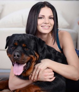 Woman hugs rottweiler